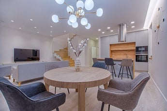 round-brown-wooden-table-with-chairs-inside-room-1668860-768x513