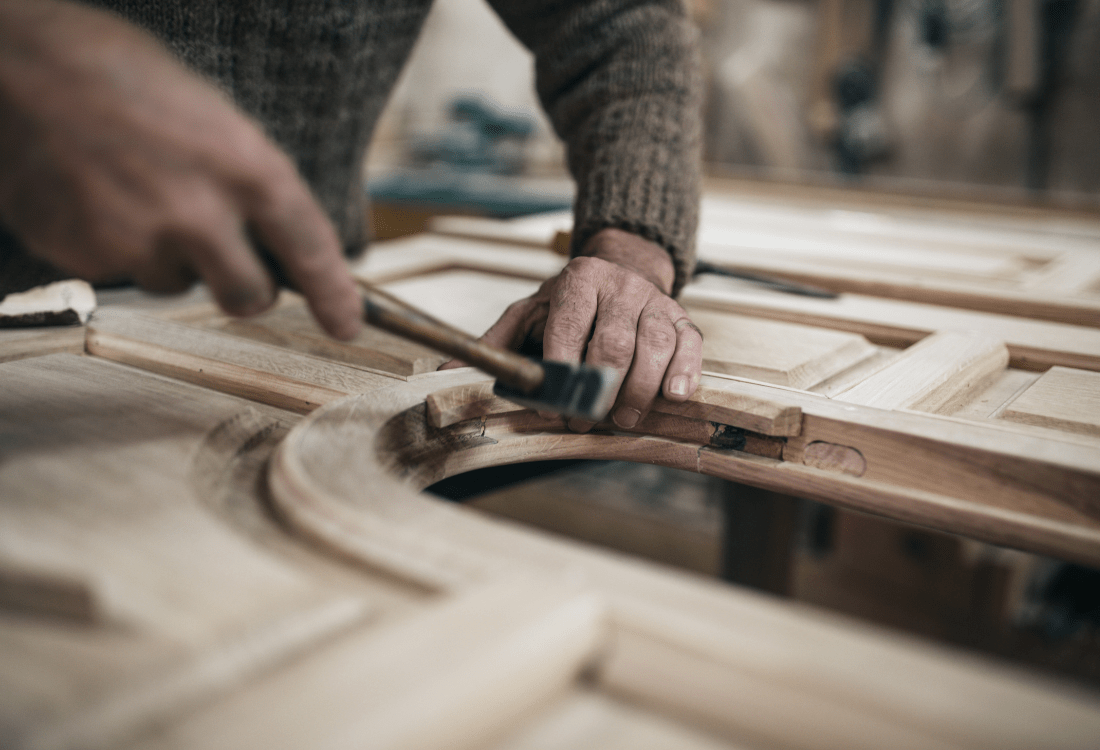 An expert craftsman at Drew Forsyth building wooden kitchen furniture for a luxury bespoke kitchen design.