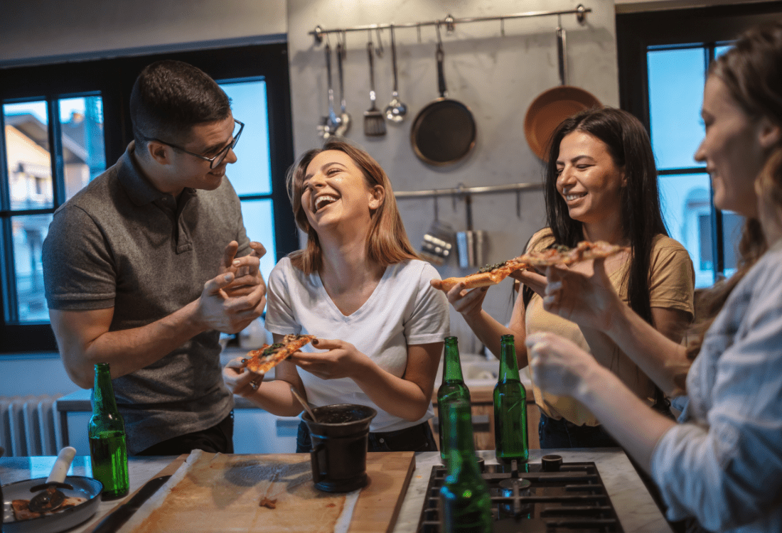 A group of friends spending a good time in a kitchen designed for guests and entertainment.